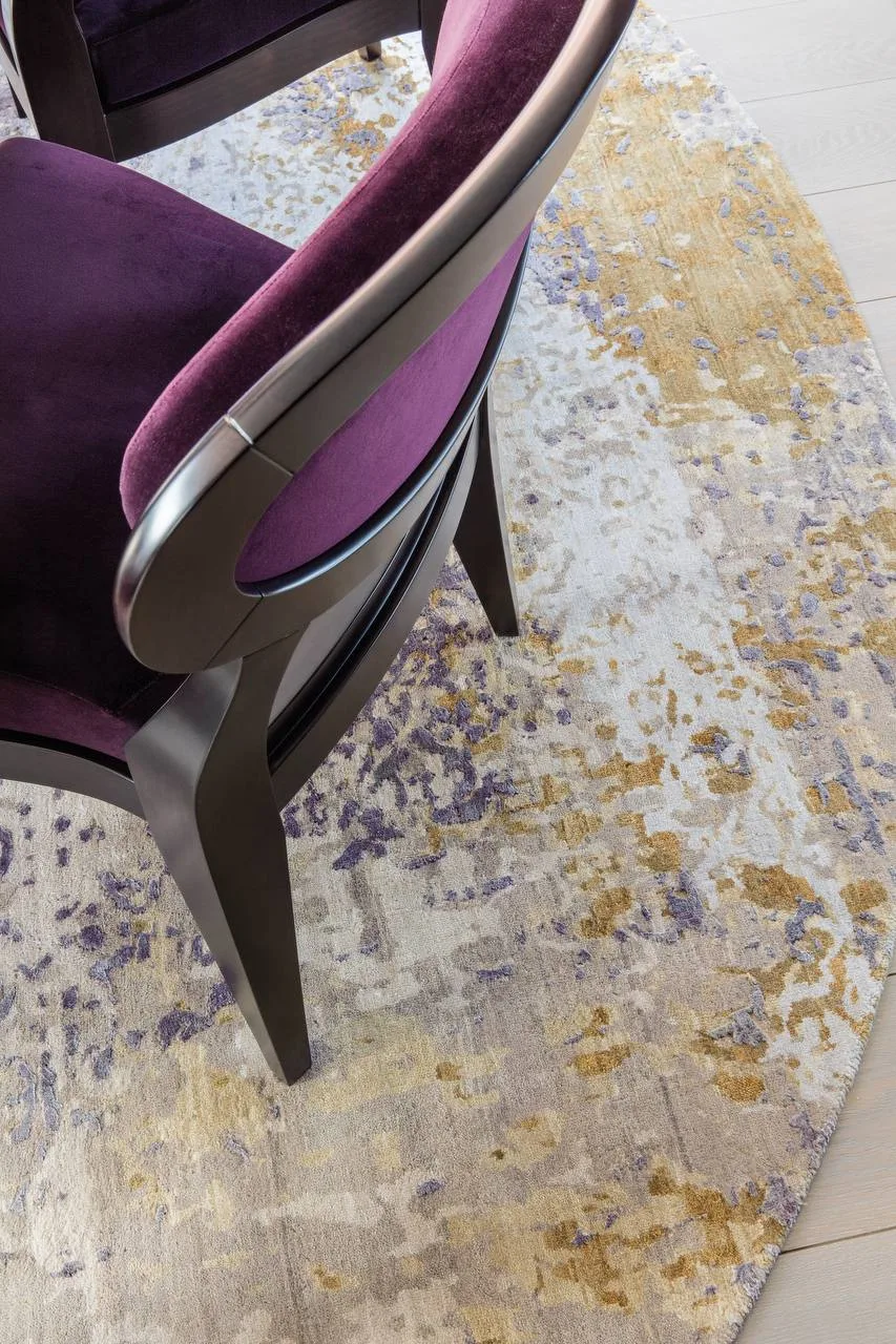 Round abstract TVR rug under a dining table